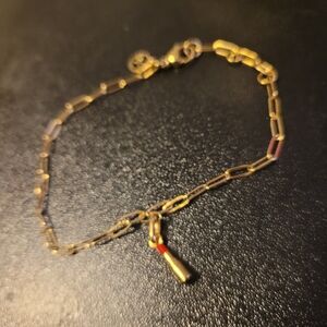 Elegant Gold Bracelet with Red Accent